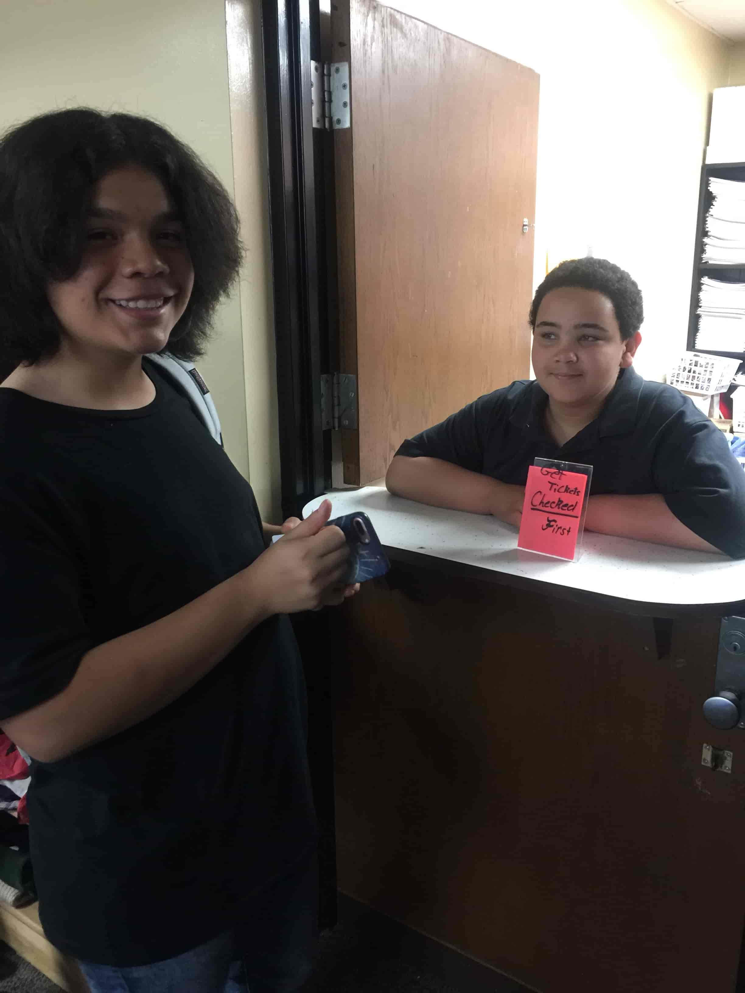 Darby Junior High students at the school store counter with a sign reading Get Tickets Checked First