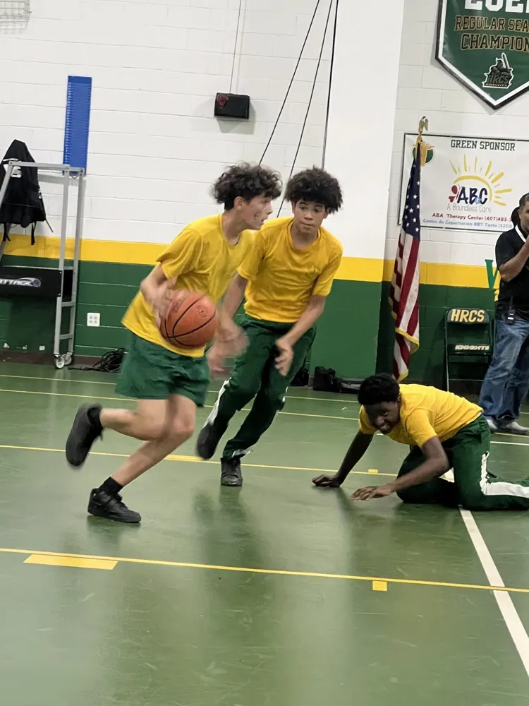 Holy Redeemer students playing basketball in the school gym during the Block Party